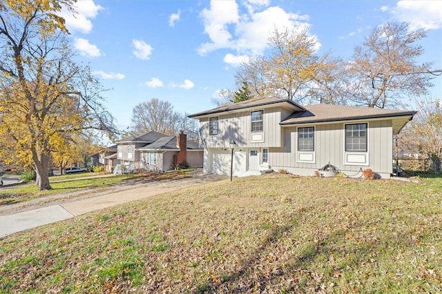 split level home with a front lawn and a garage