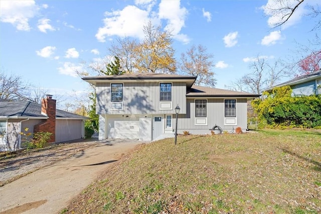 split level home with a garage and a front lawn