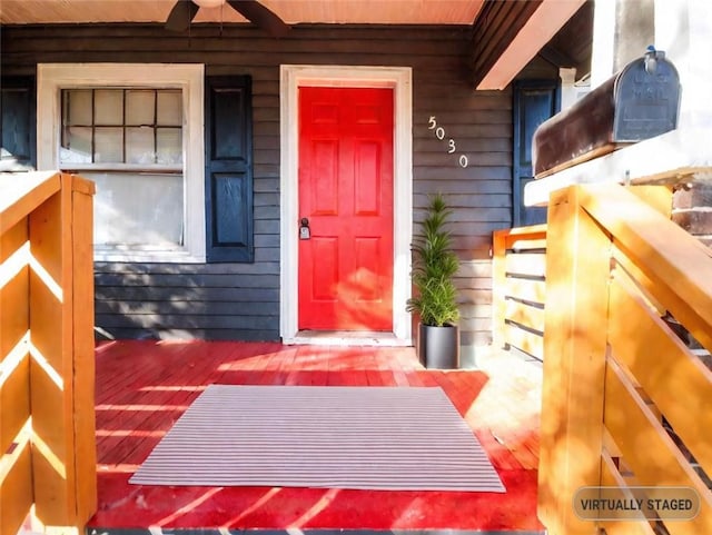 view of exterior entry with ceiling fan