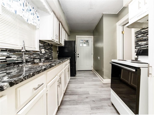 kitchen featuring tasteful backsplash, white range with electric cooktop, and white cabinetry