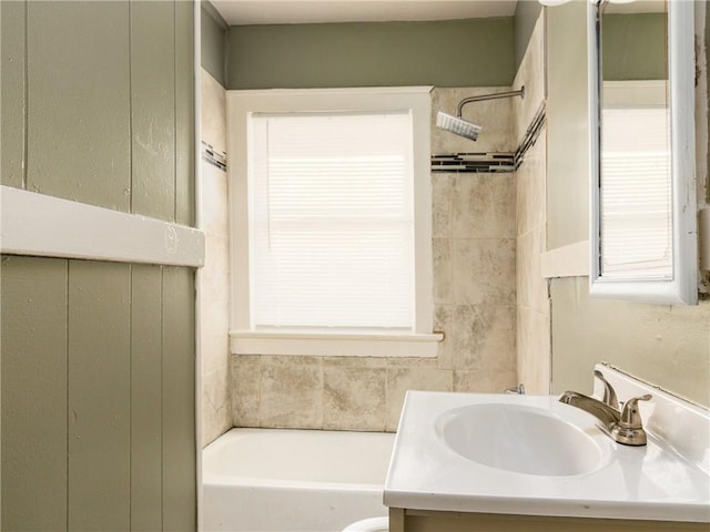 bathroom with vanity and tiled shower / bath combo