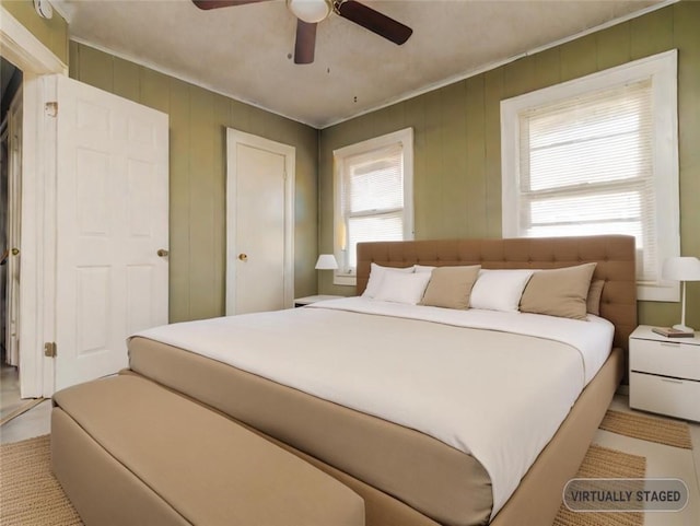 bedroom featuring ceiling fan and crown molding