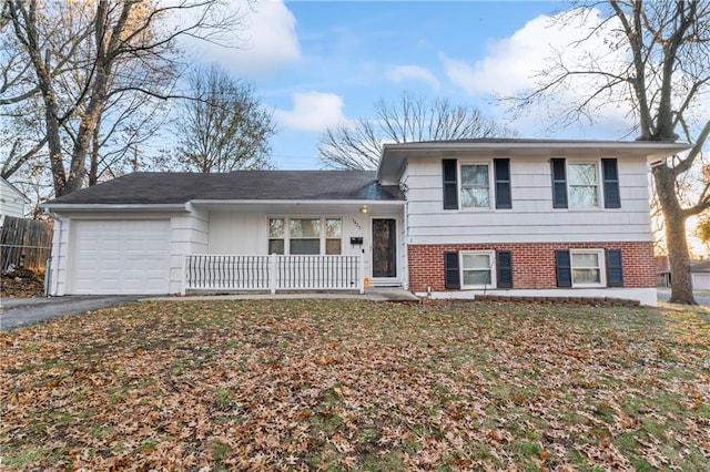 split level home featuring covered porch and a garage