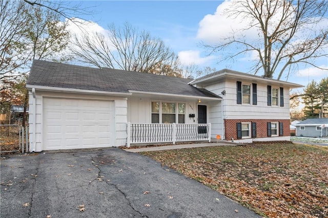 split level home featuring covered porch and a garage