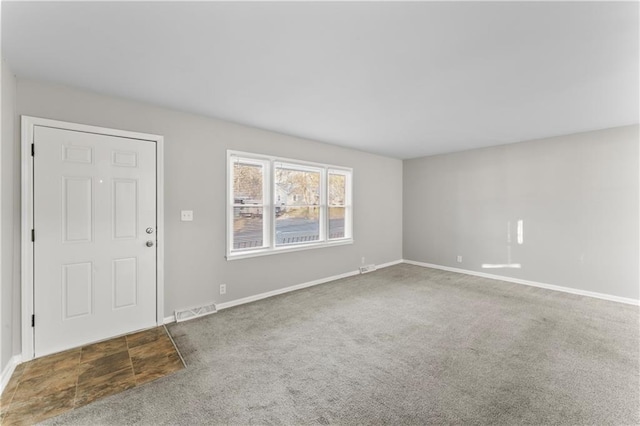 view of carpeted foyer entrance