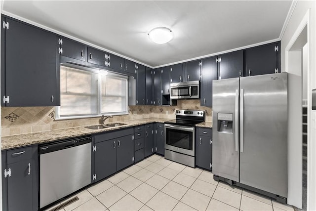 kitchen with light tile patterned floors, backsplash, stainless steel appliances, and sink