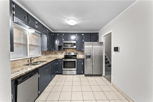 kitchen featuring sink, backsplash, appliances with stainless steel finishes, light tile patterned floors, and ornamental molding