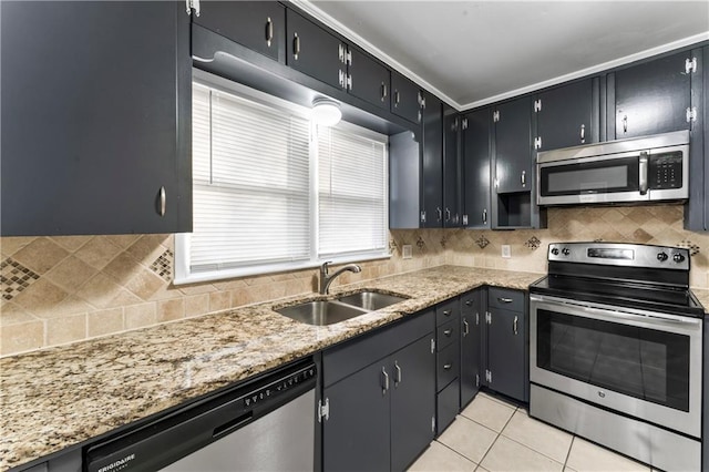 kitchen featuring light stone countertops, sink, stainless steel appliances, decorative backsplash, and light tile patterned floors