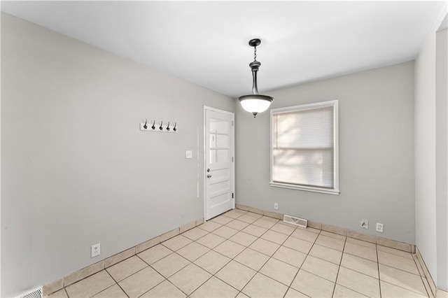 empty room with light tile patterned floors