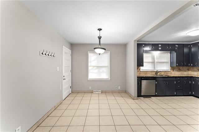 kitchen featuring dishwasher, sink, tasteful backsplash, decorative light fixtures, and light tile patterned floors