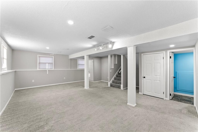 basement with light carpet and a textured ceiling