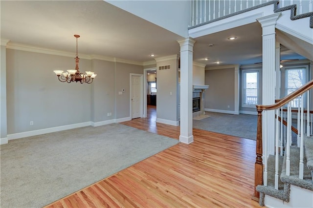 interior space featuring a chandelier, light hardwood / wood-style flooring, and ornamental molding