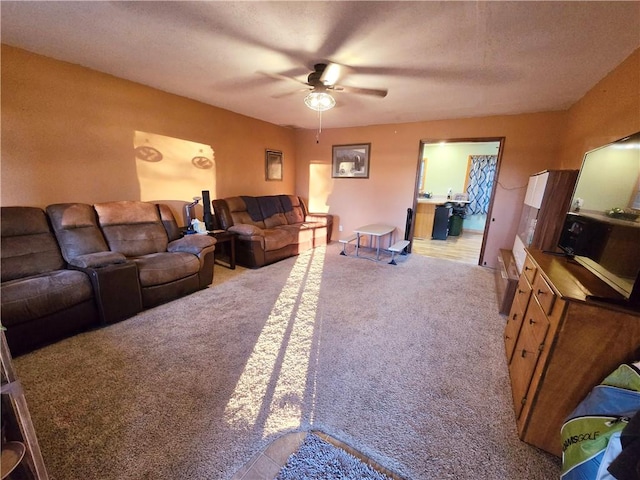 living room with light colored carpet and ceiling fan