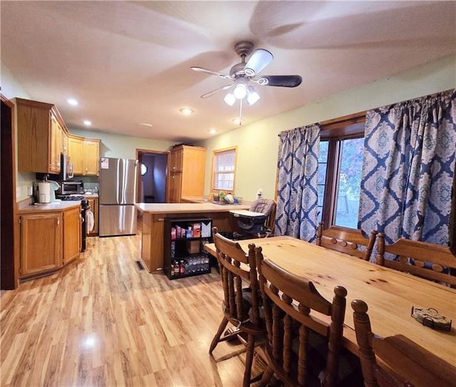 dining space with ceiling fan, light hardwood / wood-style floors, and a wealth of natural light