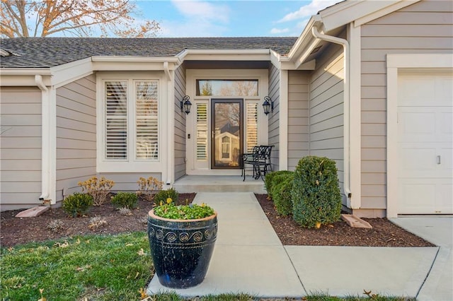 view of exterior entry with a garage