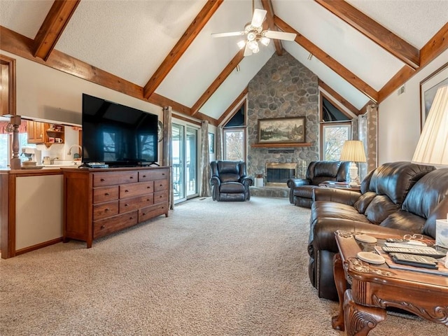 living room with beam ceiling, high vaulted ceiling, a stone fireplace, and light colored carpet