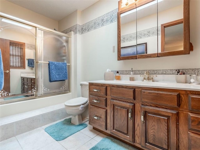 full bathroom with tile patterned flooring, vanity, toilet, and bath / shower combo with glass door