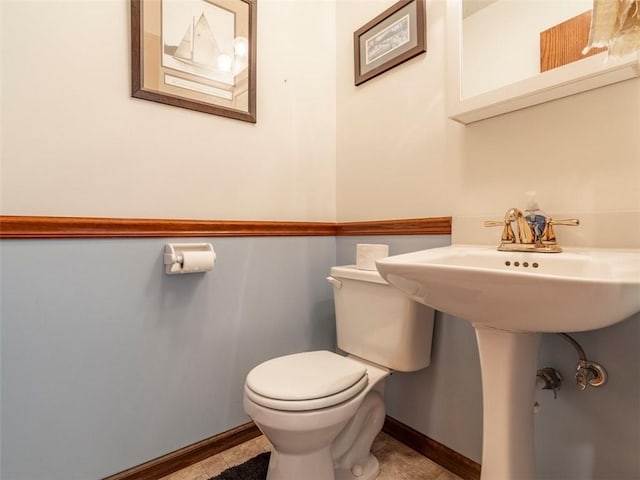 bathroom featuring tile patterned floors and toilet