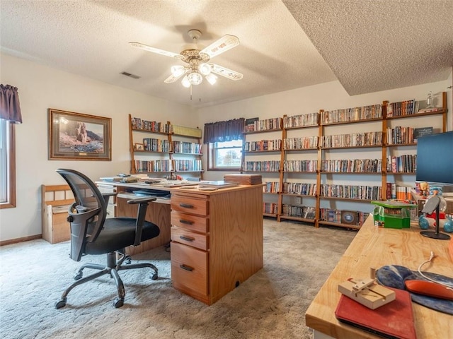 office space with a textured ceiling, carpet floors, and ceiling fan