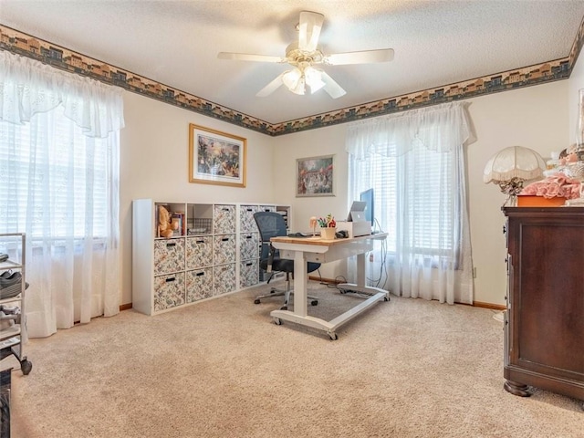 office area featuring ceiling fan, light colored carpet, and a textured ceiling