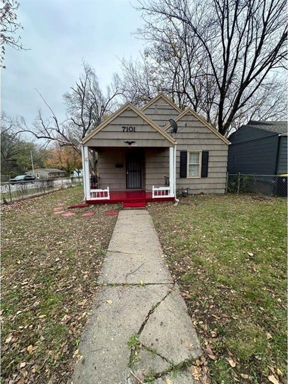 bungalow-style house with covered porch and a front yard