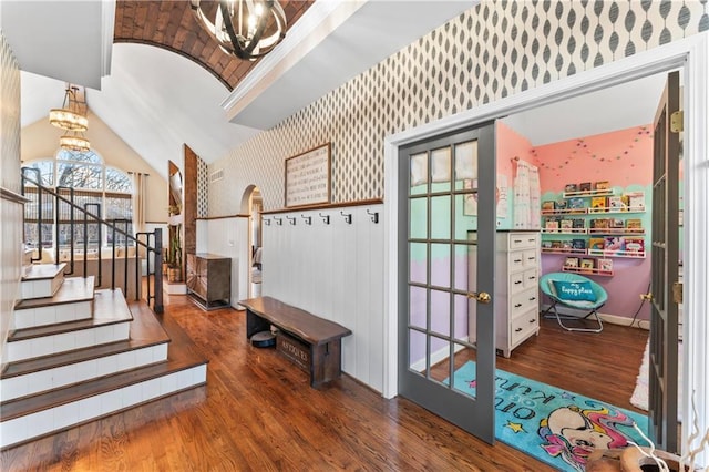 entryway featuring vaulted ceiling, a chandelier, and dark hardwood / wood-style floors