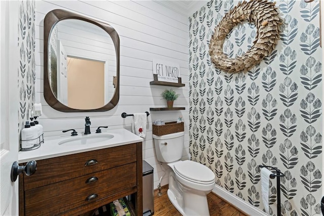 bathroom with vanity, toilet, and wood-type flooring