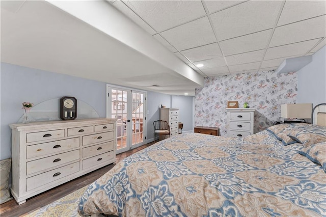 bedroom featuring a paneled ceiling, dark hardwood / wood-style floors, and french doors