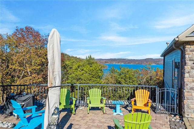 balcony featuring a water view and a patio