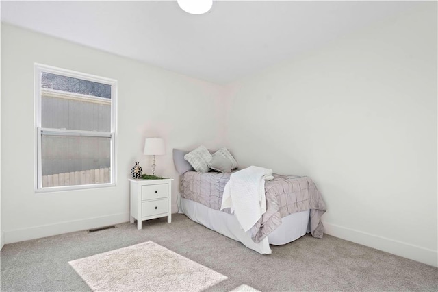 bedroom featuring baseboards, visible vents, and carpet floors