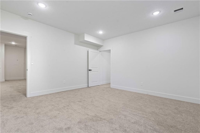 spare room with visible vents, recessed lighting, baseboards, and carpet floors