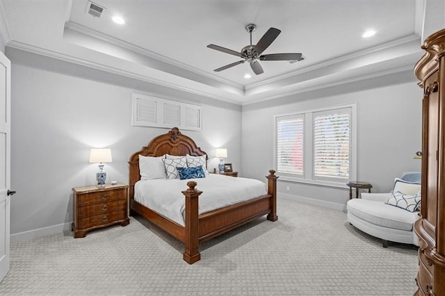 carpeted bedroom with ornamental molding, ceiling fan, and a tray ceiling