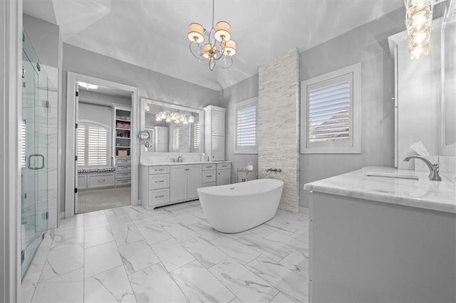 bathroom featuring vanity, shower with separate bathtub, and an inviting chandelier