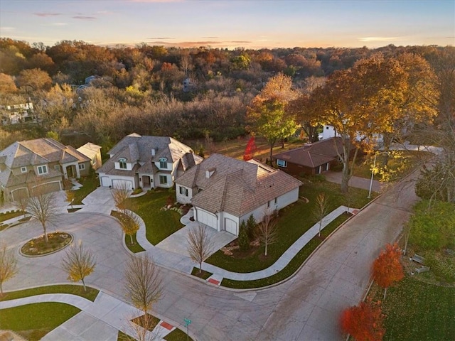 aerial view at dusk featuring a residential view