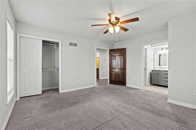 unfurnished bedroom featuring visible vents, baseboards, a ceiling fan, carpet, and a closet