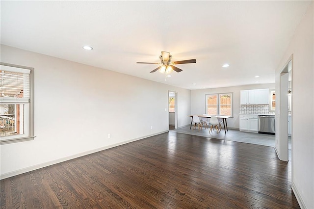 unfurnished living room featuring dark hardwood / wood-style floors and ceiling fan