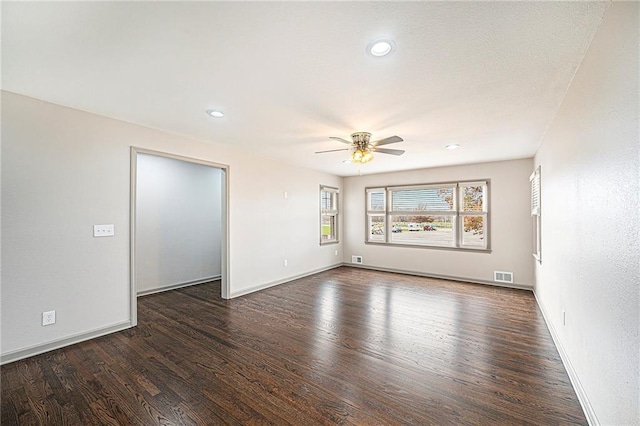 empty room featuring ceiling fan and dark wood-type flooring