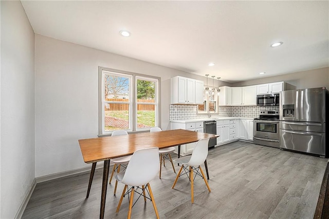 dining space featuring light hardwood / wood-style flooring and sink