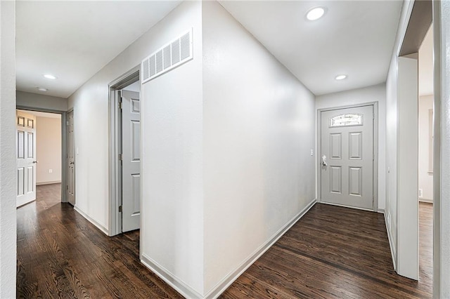 hallway with dark hardwood / wood-style flooring