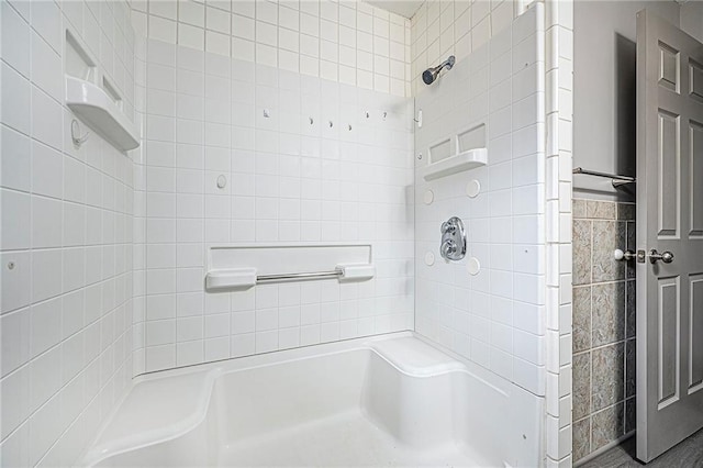 bathroom featuring tile walls and tiled shower