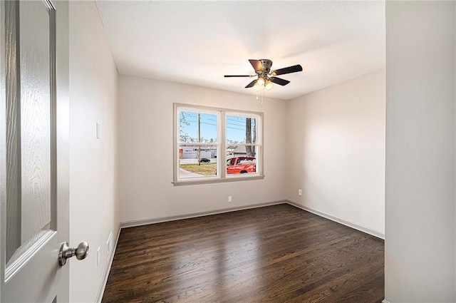 empty room featuring dark hardwood / wood-style floors and ceiling fan