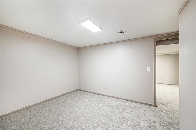 spare room with light colored carpet and ornamental molding