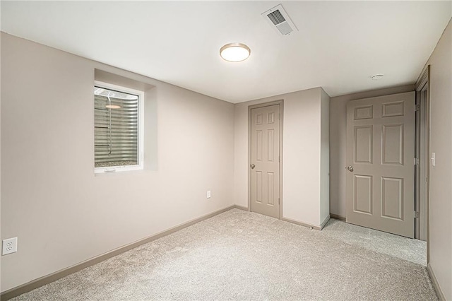 unfurnished bedroom with light colored carpet and a closet