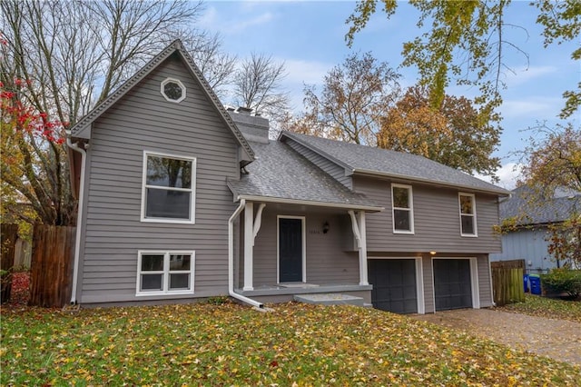 split level home with a front yard and a garage