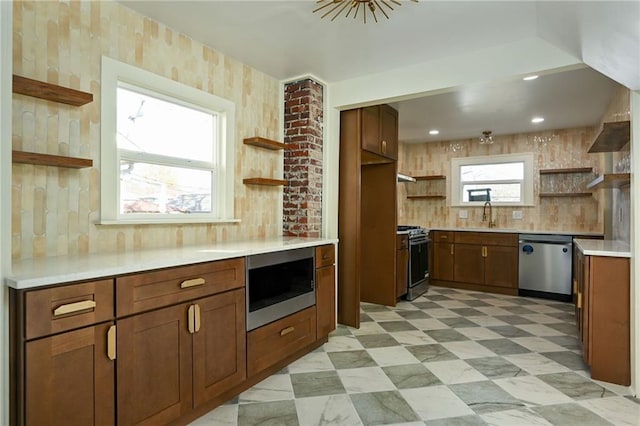 kitchen featuring appliances with stainless steel finishes, backsplash, and sink