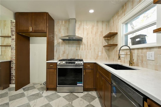 kitchen featuring sink, wall chimney range hood, black dishwasher, light stone counters, and stainless steel stove