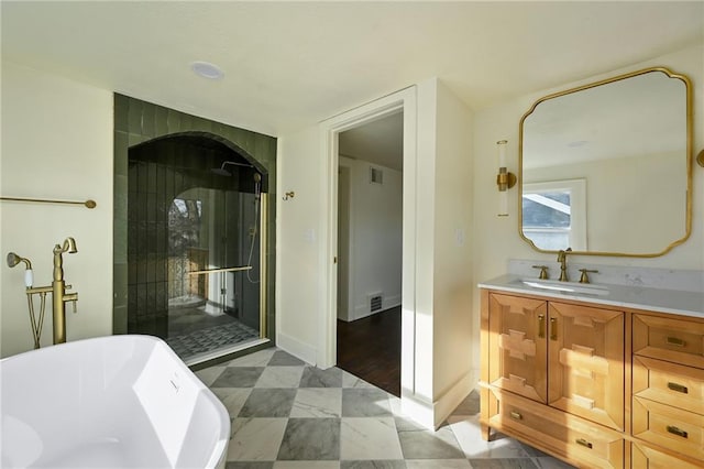 bathroom featuring wood-type flooring, vanity, and a tub to relax in