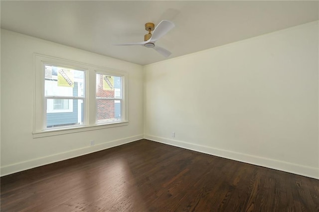 spare room featuring ceiling fan and dark wood-type flooring