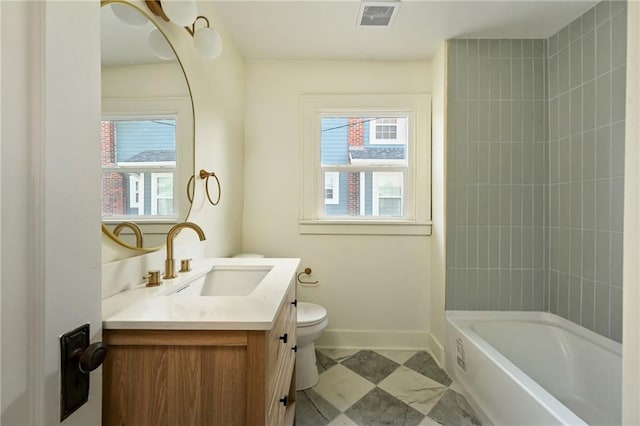 full bathroom with vanity, toilet, and tiled shower / bath combo