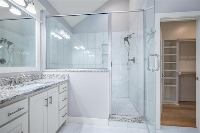 bathroom featuring tile patterned flooring, vanity, and a shower with shower door